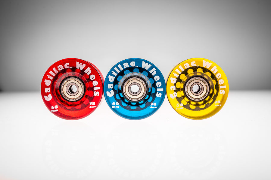 Three Santoro Fabworx Cadillac crash bar wheels in red, blue and gold with Cadillac Wheels branding
