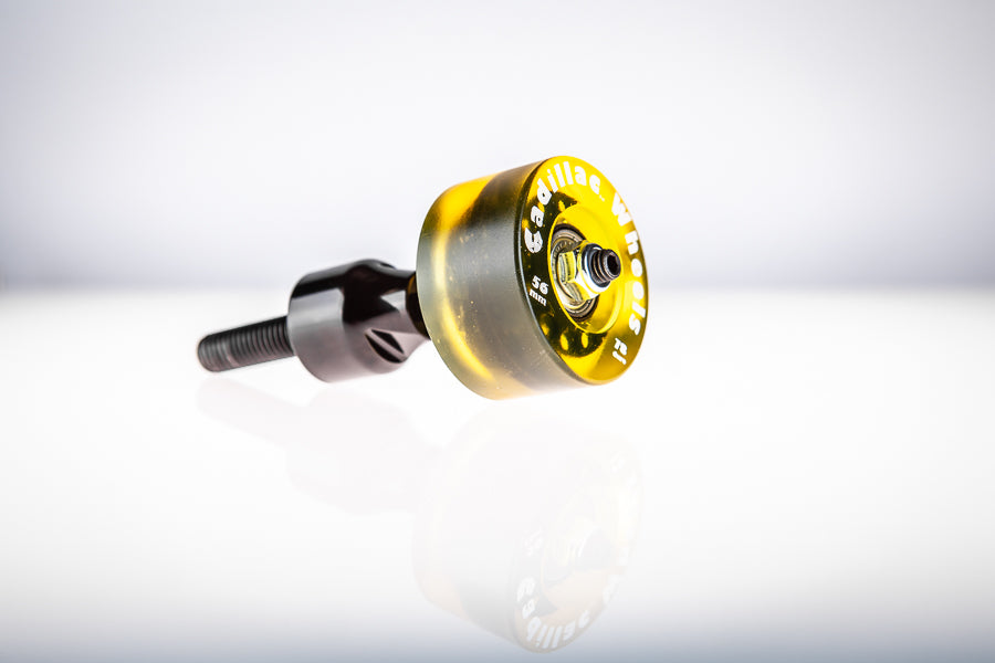 Gold-amber translucent Santoro Fabworx Cadillac crash bar wheel on black mount, studio product photo on white background