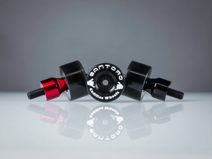 Santoro Fabworx red Cadillac crash bar wheel with Santoro branding, pair on reflective surface