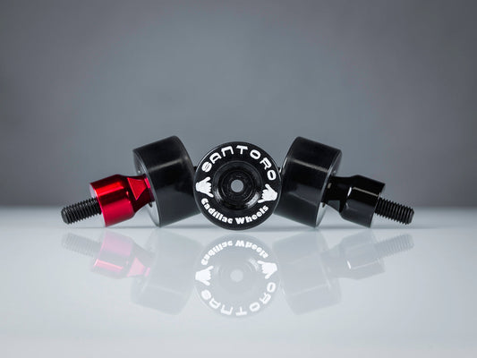 Santoro Fabworx red Cadillac crash bar wheel with Santoro branding, pair on reflective surface