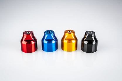 Four Santoro Fabworx Cadillac crash bar wheel mounts in red, blue, gold and black, close view on a white background