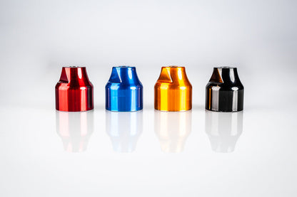 Four Santoro Fabworx Cadillac crash bar wheel mounts in red, blue, gold and black on a reflective surface