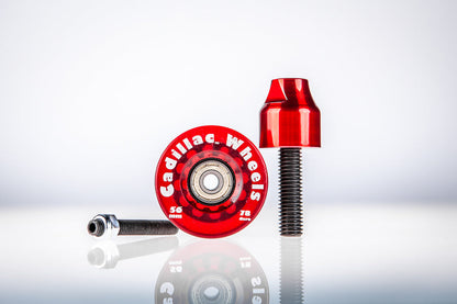 Red Santoro Fabworx Cadillac crash bar wheel with red mount and bolt on a reflective surface