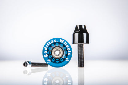 Blue Santoro Fabworx Cadillac crash bar wheel with black mount and bolt on a reflective surface