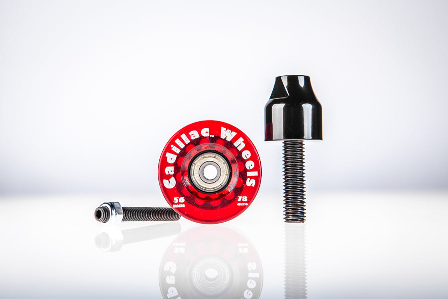 Red Santoro Fabworx Cadillac crash bar wheel with black mount and bolt on a reflective surface