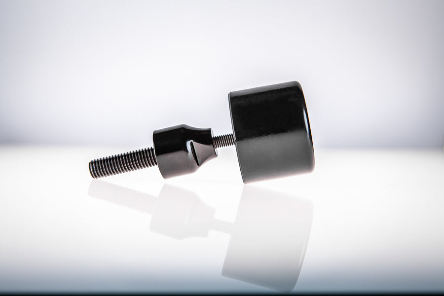 Black Santoro Fabworx Cadillac crash bar wheel with black mount and bolt on a reflective surface