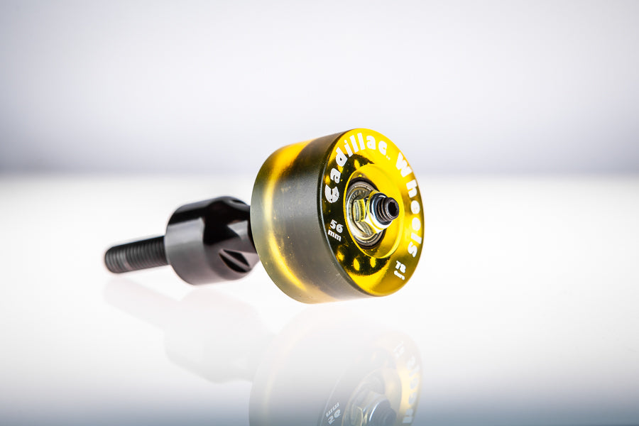 Gold-amber translucent Santoro Fabworx Cadillac crash bar wheel on black mount, side view on a white background