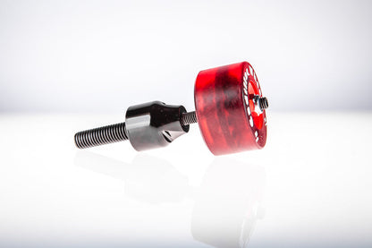 Red Santoro Fabworx Cadillac crash bar wheel with black mount and bolt, rear side view on a reflective surface