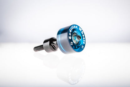 Blue Santoro Fabworx Cadillac crash bar wheel with black mount and bolt, close side view on a reflective surface